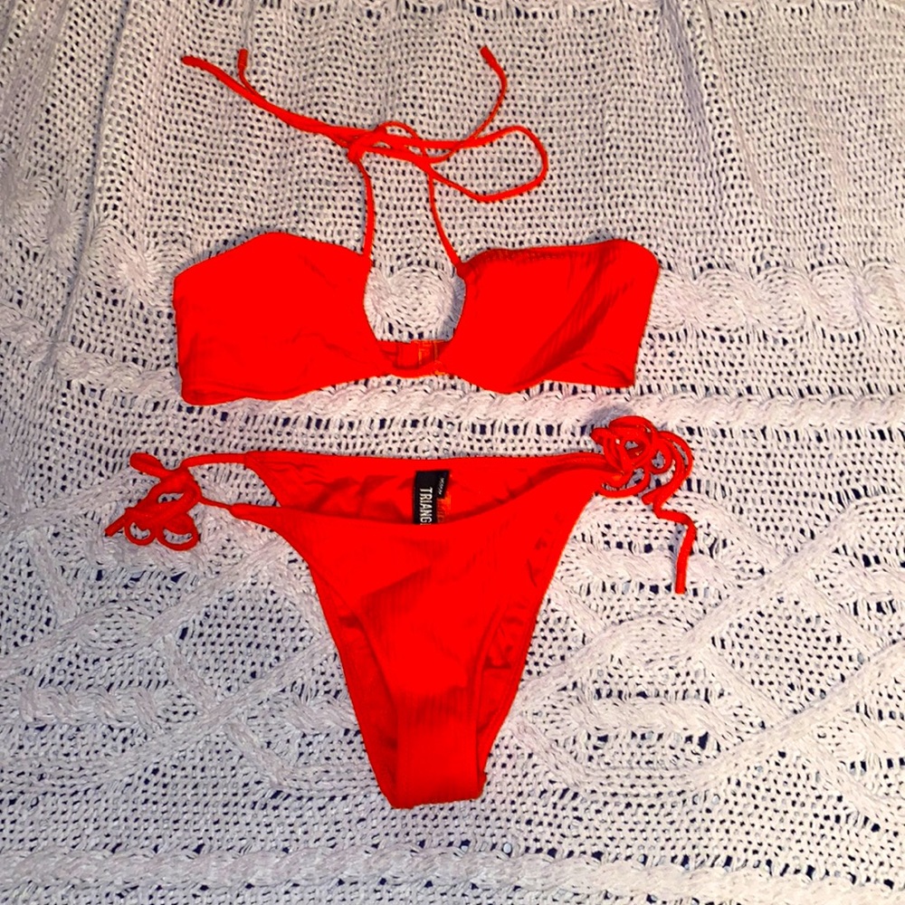 Triangl Bikini. Never worn. Selling top and bottom. Both size medium.